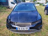 a black car that is parked in the grass