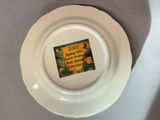 a white plate with a picture on it on a table