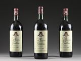 three bottles of wine sitting on top of a table next to each other