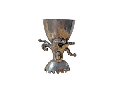 a silver cup that is sitting on a stand