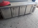 a red lid sitting on top of a stainless steel counter