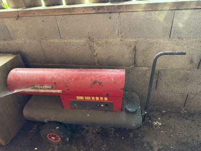 a red fire extinguisor sitting in the corner of a building