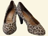 pair of women ' s leopard print pumps on a white background