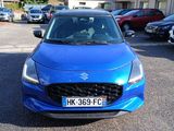 a blue car that is parked in a parking lot