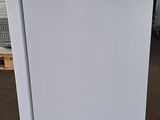 a white refrigerator that is sitting in a warehouse