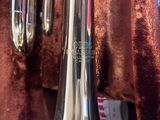 a silver trumpet that is sitting on a table
