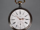 a silver pocket watch with roman numerals on it