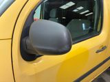 a yellow car with a black side mirror and a checkered floor