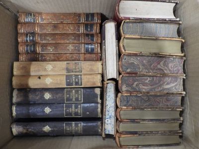 a box full of old books sitting on the floor