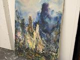 un tableau représentant un paysage de montagne posé sur une table