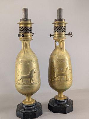 pair of antique brass vases on marble bases with a horse and carriage motif