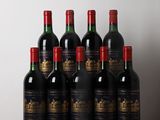 bottles of wine are lined up on a table in front of a white wall