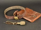an old leather belt with a brass buckle and a leather case