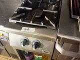 two stoves that are in a kitchen next to each other