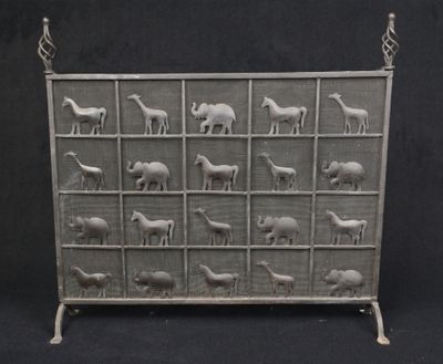 a metal screen with animals on it on a black background
