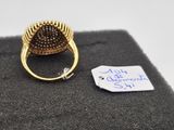 a gold ring with a black diamond on it