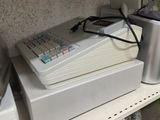 a cash register and a blender on a shelf