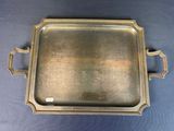a silver tray with handles and handles on a blue background