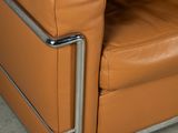 a brown leather chair that is sitting in a room