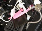an image of a car ' s trunk with a pink and white device in it