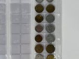 a lot of different coins in a plastic case