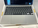a laptop computer sitting on top of a white box