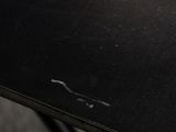 a close up of a black table with a white plate on it
