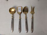 five spoons and a fork on a table