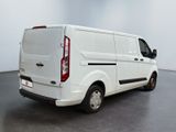 the back of a white van parked in a large room