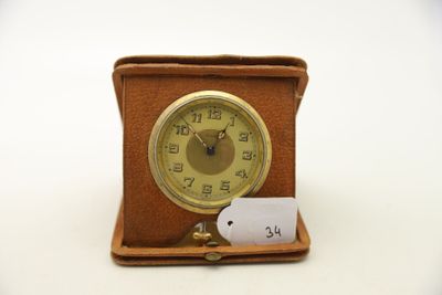 une petite horloge avec une étiquette, posée sur une table