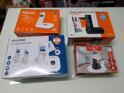three boxes of cell phones sitting on a table next to each other