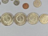 a lot of coins that are on the table