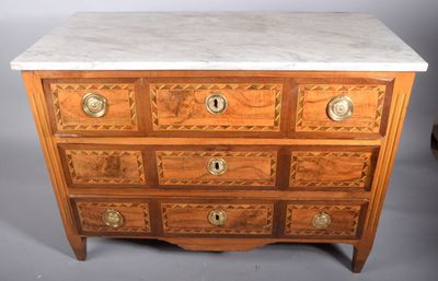 a marble top chest of drawers on display