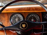 steering wheel and dashboard of a classic car with gauges and gauges