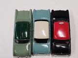 several toy cars are lined up in a row on a white surface