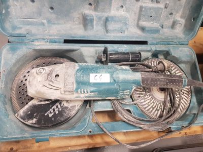 a blue tool in a case on a wooden table