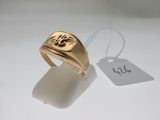 a gold signet ring with a bird on it and a price tag