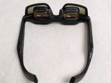 a pair of glasses on a table with a pair of glasses on top of it