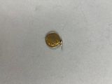 a close up of a gold coin on a white surface