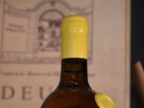 a bottle of wine sitting on a table next to a book