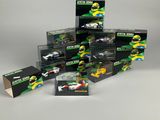 a group of toy cars are stacked up on a white surface