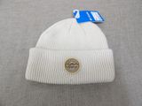 a close up of a white hat with a badge on it