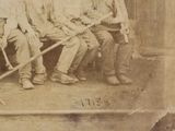 a old photo of a group of men sitting on a bench