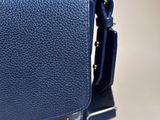a blue leather bag with a geometric pattern on the front