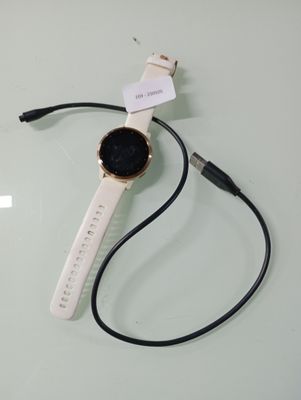 a watch that is connected to a charger on a table