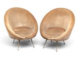 pair of mid - century modern lounge chairs in the style of eero