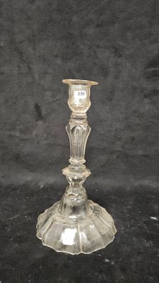 a clear glass candle holder on a black background