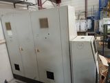 an image of a refrigerator in a factory with other appliances in the background