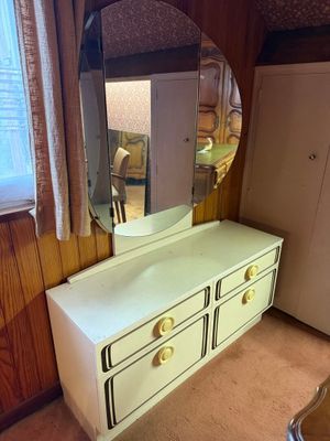 a white dresser with a mirror on it in a room