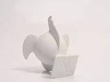 a figurine of a bird that is sitting on a table